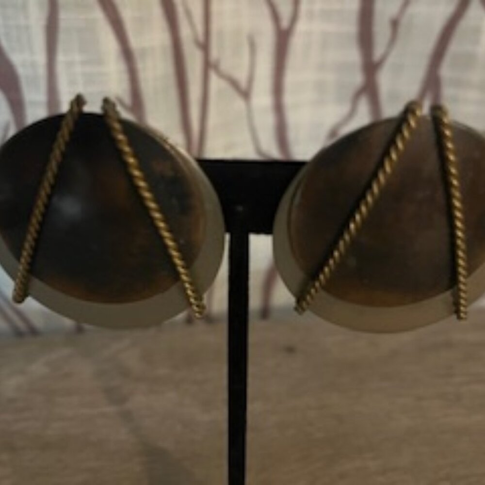 Vintage brass-toned metal clip-on earrings with a domed design.